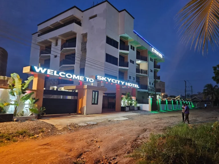 Skycity Hotel in Amrahia, Accra, lit up at twilight with its illuminated welcome sign