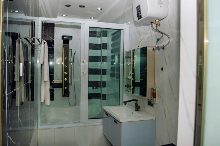 Marble bathroom with glass rain shower at Skycity Hotel