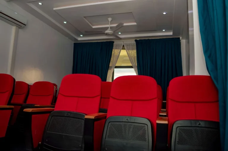Conference hall with blue drapes and red seating at Skycity Hotel
