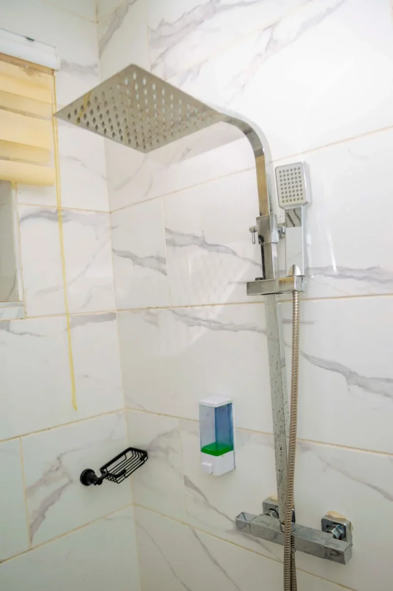 Rain shower head in a marble bathroom at Skycity Hotel