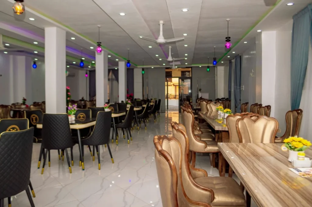 Spacious restaurant dining hall at Skycity Hotel with gold upholstered chairs