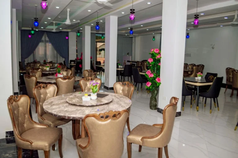 Round dining tables and gold chairs in the Skycity Hotel restaurant