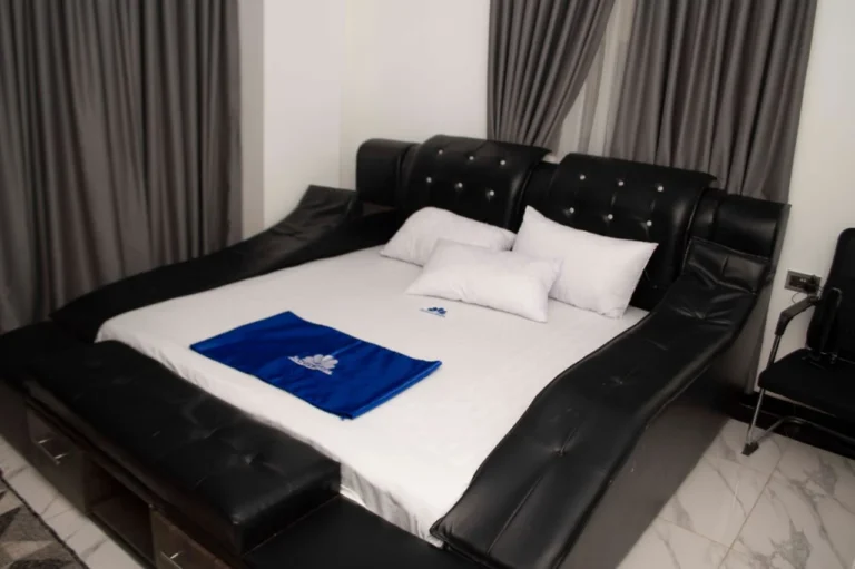 Leather king bed by the window at Skycity Hotel