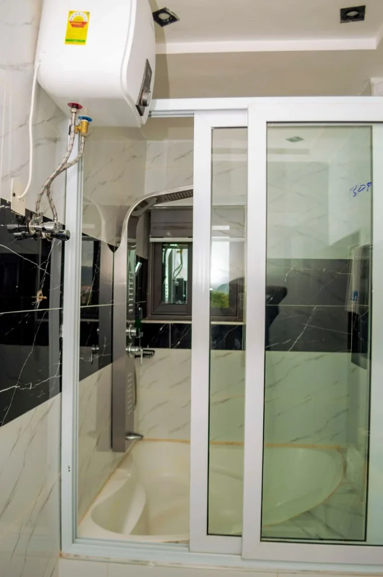 Glass shower enclosure with water heater at Skycity Hotel